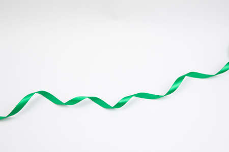 long green ribbon, white backgroundの写真素材