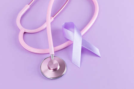Pink stethoscope and purple ribbon, light purple backgroundの写真素材