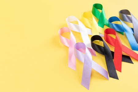 colorful ribbons on yellow backgroundの写真素材