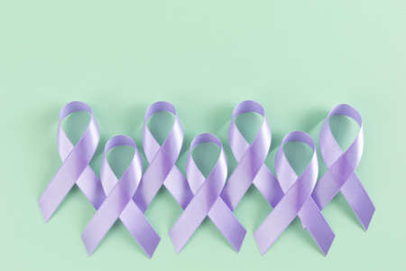 purple ribbon on mint color background