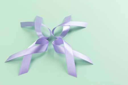 purple ribbons in star shape on mint colored backgroundの写真素材