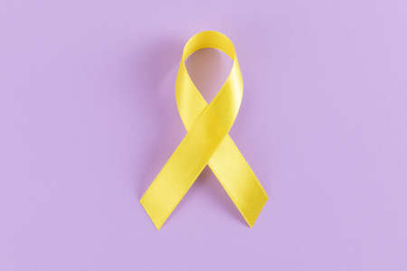 Yellow ribbon on purple backgroundの写真素材