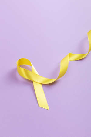 Yellow ribbon on purple backgroundの写真素材