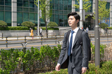 first day of newly recruited Asian man employee in smart casual suit
