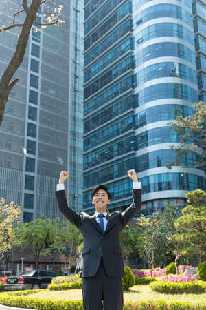 happy young Asian handsome employee man, success or achievement conceptの写真素材