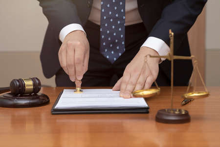 crime and legal concept, judge stamping seal on document, paper