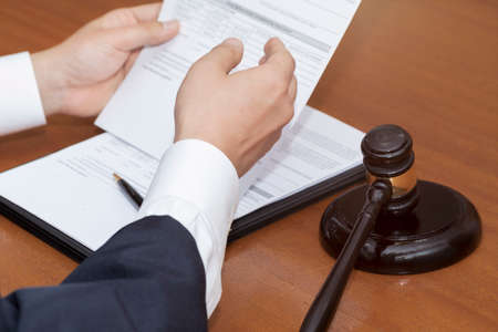 hand of judge, gavel and papers