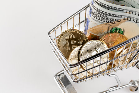 miniature shopping cart with bitcoin and dollarsの写真素材
