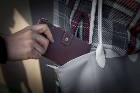 pick pocket wallet from bagの写真素材