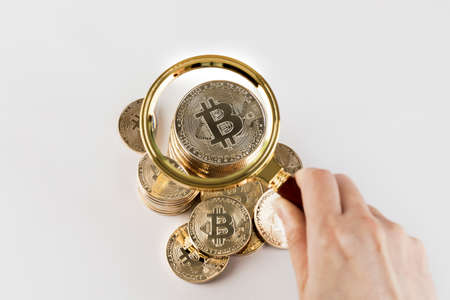 bitcoin and magnifying glass