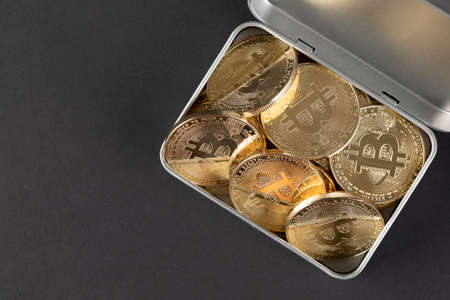 tin case filled with bitcoin, cryptocurrency concept