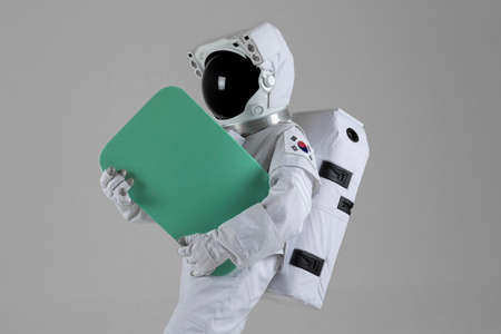Astronaut holding an event banner, white backgroundの写真素材