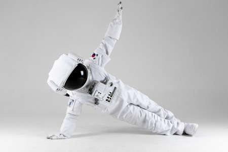 Astronaut doing exercise, white backgroundの写真素材