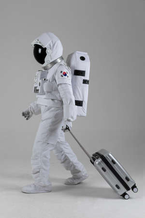astronaut walking with carrier, white backgroundの写真素材