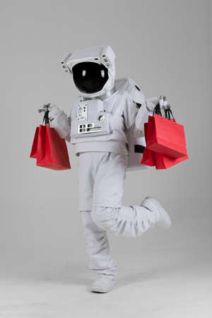astronaut happy with shopping bag, white backgroundの写真素材
