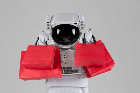 astronaut happy with shopping bag, white backgroundの写真素材