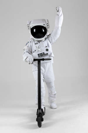 Astronaut on electric kickboard, white background