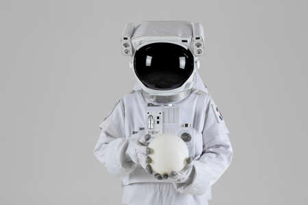 Astronaut holding mood light, white background
