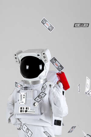 Astronaut with money gun, white background
