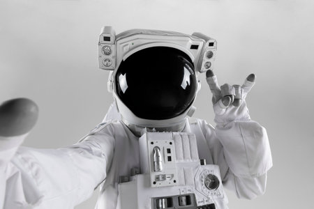 astronaut with rock and roll hand gesture, white backgroundの写真素材
