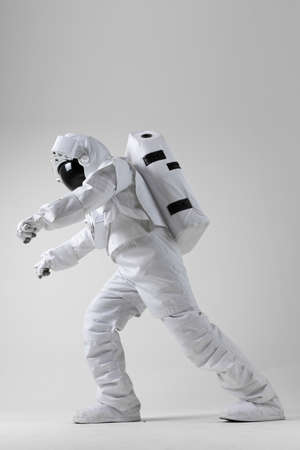 Astronaut stretching before exercise, white backgroundの写真素材