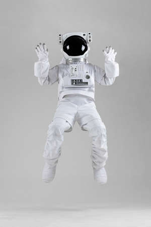 Astronaut jumping, white background
