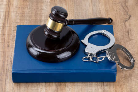 Crime and law - gavel placed on the cuffs and Codeの写真素材