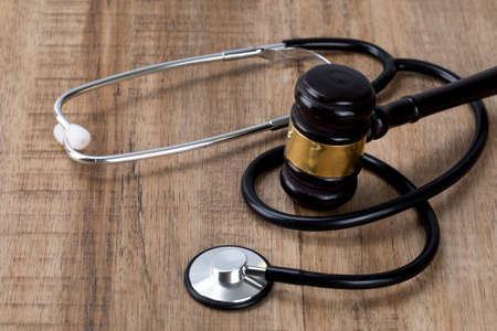 Crime and law - stethoscope and gavelの写真素材