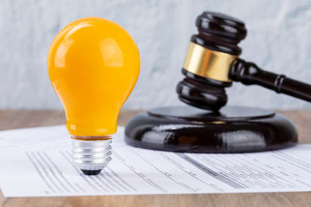 Crime and law - Documents and yellow bulbs and gavelの写真素材