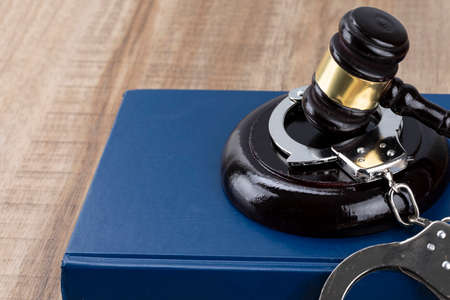 Crime and law - gavel placed on the cuffs and Codeの写真素材