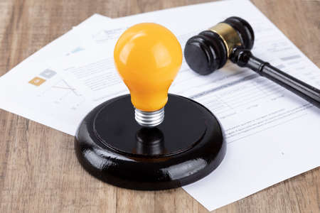 Crime and law - Documents and yellow bulbs and gavelの写真素材