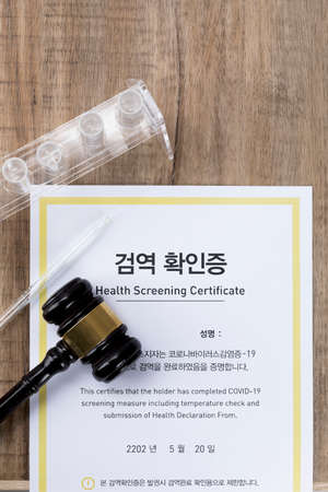 Crime and law - quarantine voucher and test tubes, dropper with a magnifying glass and gavelの写真素材