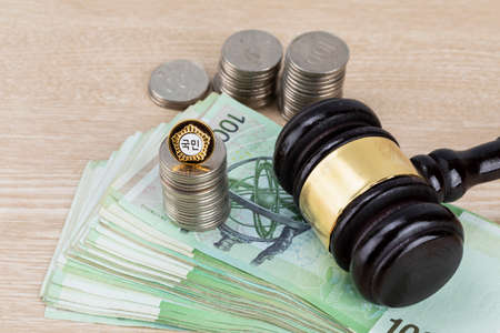 Crime and law - bribe concept, parlimamentary government badge, coins and moneyの写真素材
