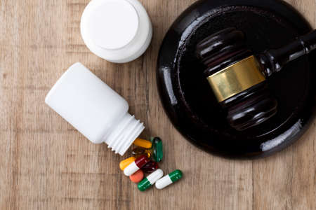 Crime and law - pills and pill bottle and gavelの写真素材