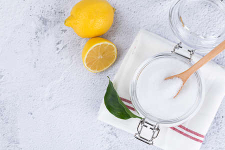 Zero waste cleaning - powdered citric acid, wood spoon and lemonの写真素材