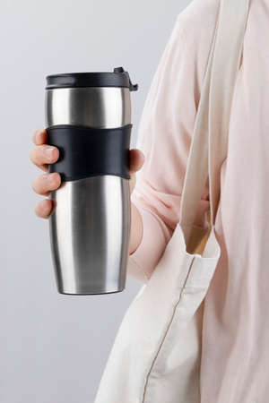Zero waste - person carrying eco bg and tumblerの写真素材