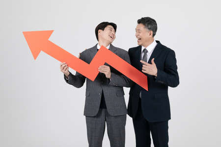 business concept Korean Asian old and young men holding graph chart