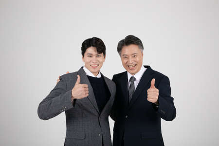 business concept Korean Asian old and young men with hand motionの写真素材