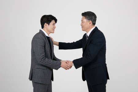 business concept Korean Asian old and young men requesting actionの写真素材
