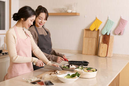 beautiful asian korean women cooking home meal kitの写真素材