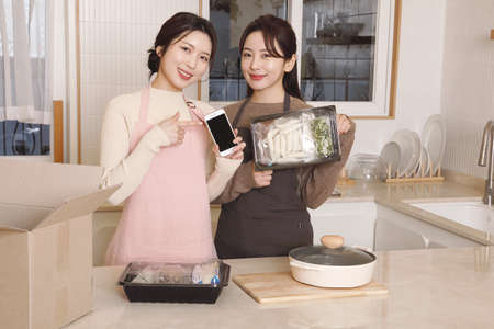 beautiful asian korean women cooking home meal kitの写真素材