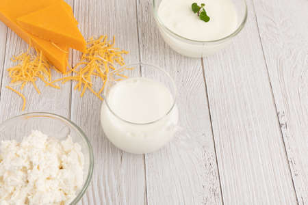 milk and yogurt cheese collection, white wood background