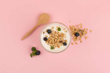 yogurt with fruits and granola, pink background