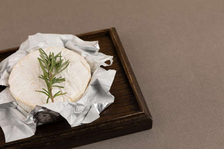 rosemary herb, brie cheese, brown backgroundの写真素材
