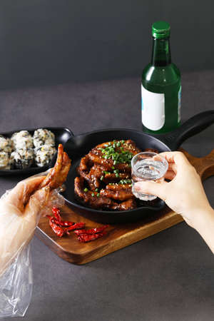 Soju drink and Korean finger foods, chicken feet with rice ballの写真素材