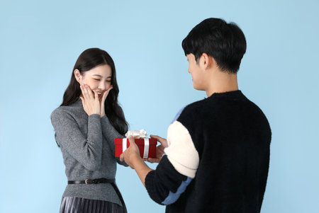 Asian Korean couple sharing gifts, promotion and sale conceptの写真素材