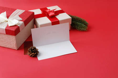 Christmas gift box and ornaments in red backgroundの写真素材