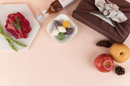 Korean holiday Chuseok and Seol gift set of fruits, rice cake, pine cone and silk wrapped gift boxの写真素材