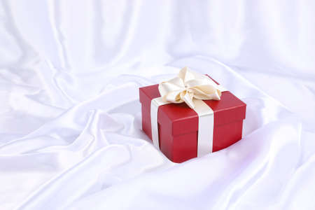 red gift box and white fabric backgroundの写真素材