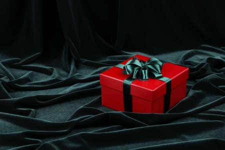 red gift box and dark green fabric background, Christmas conceptの写真素材